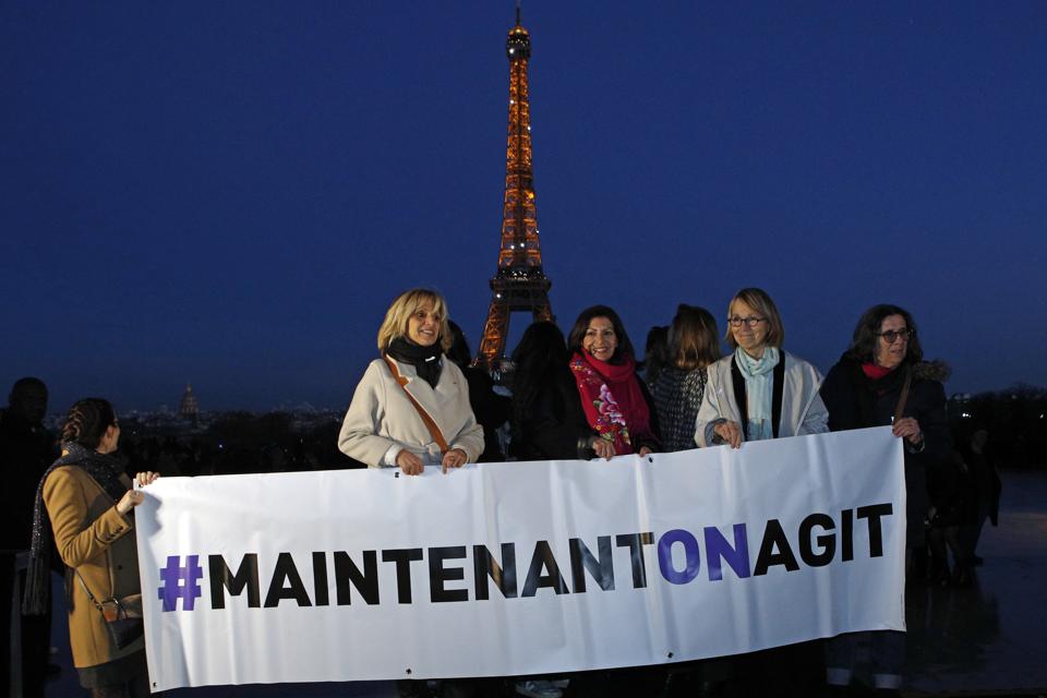 French Culture Minister Francoise Nyssen, second right, Paris mayor Anne Hidalgo, center, and... [+] members of several women's rights associations hold a banner reading "Maintenant On Agit" ("Now We Act") on the eve of International Women's Day to honor women's rights and promote the French equivalent of the Time's Up movement in Paris, Wednesday, March 7, 2018. Launched by the Foundation of Women, the movement aims to raise funds for associations helping women pursue cases before justice, "so that no woman ever again has to say #MeToo." (AP Photo/Francois Mori)