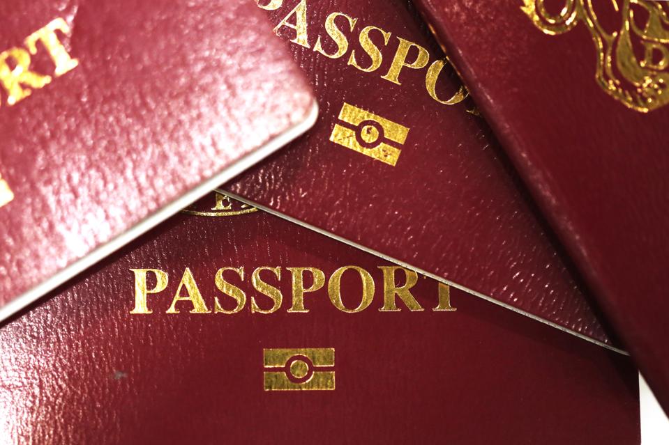 A collection of burgundy red British passport, issued by the U.K. Government and introduced in 1988,... [+] sit in this arranged photograph in London, U.K., on Friday, April, 6, 2018. The U.K. delayed a final decision on who will manufacture the country’s post-Brexit blue passports, after criticism from the media and a losing bidder, De La Rue Plc, over the designation of a Franco-Dutch firm as the government’s preferred choice. Photographer: Chris Ratcliffe/Bloomberg