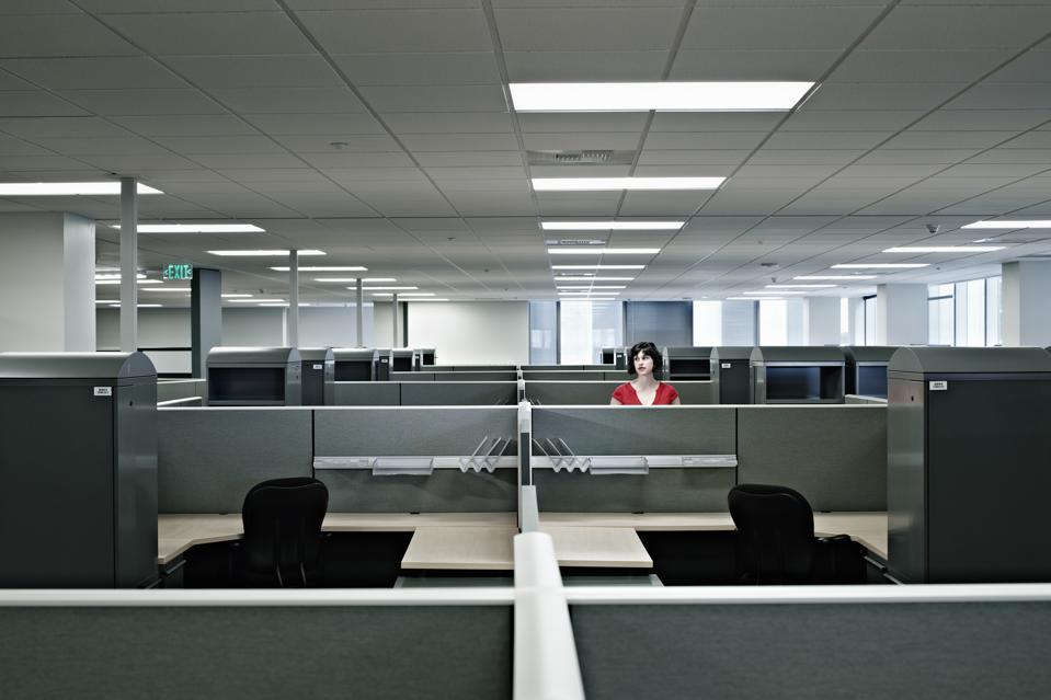 Businesswoman standing alone in empty office