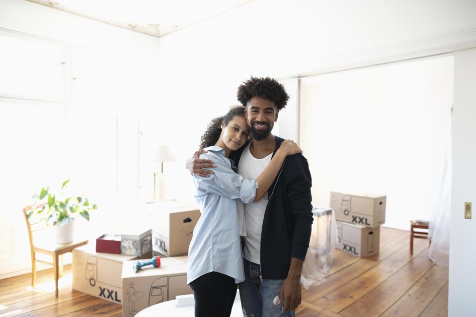 Homebuilder Shares Tips For First Time Home Buyers Portrait affectionate, confident couple moving into new home