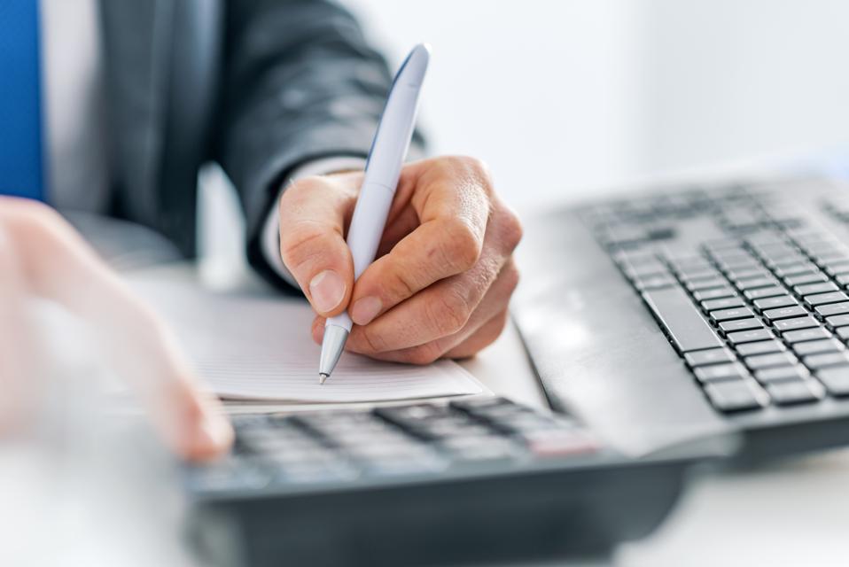 Business man using calculator