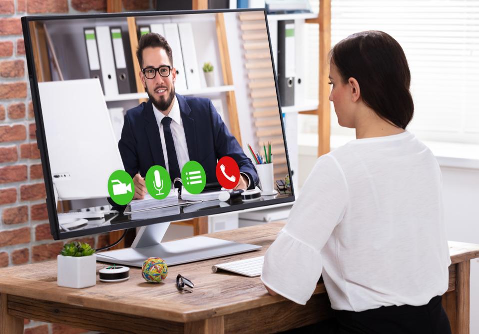 Businesswoman Video Conferencing With Businessman