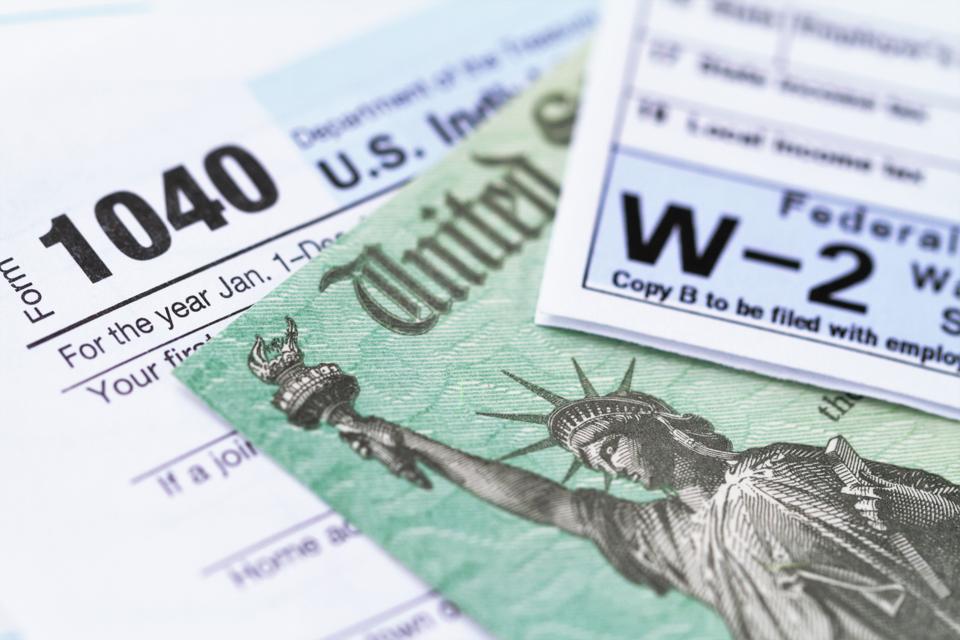 IRS tax forms with tax refund check