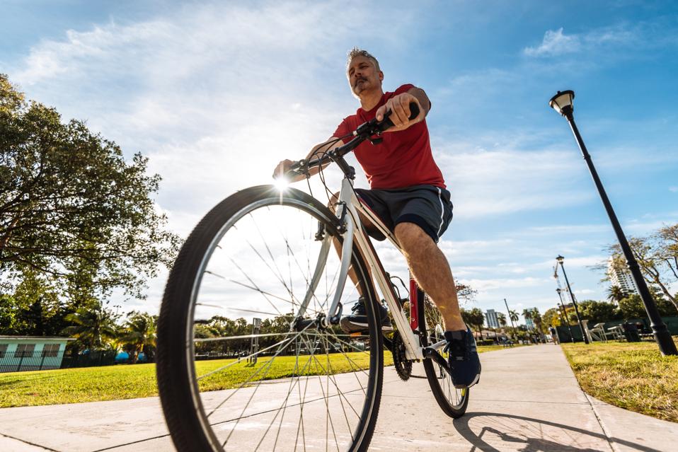 Mature caucasian man riding bicycle in Miami, USA