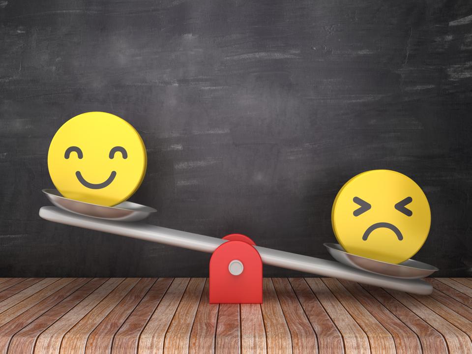 Seesaw Scale with Emoticons on Chalkboard Background - Happy up, Sad down