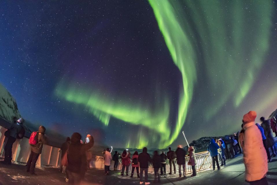 Aurora tourists taking in the sky show on March 14