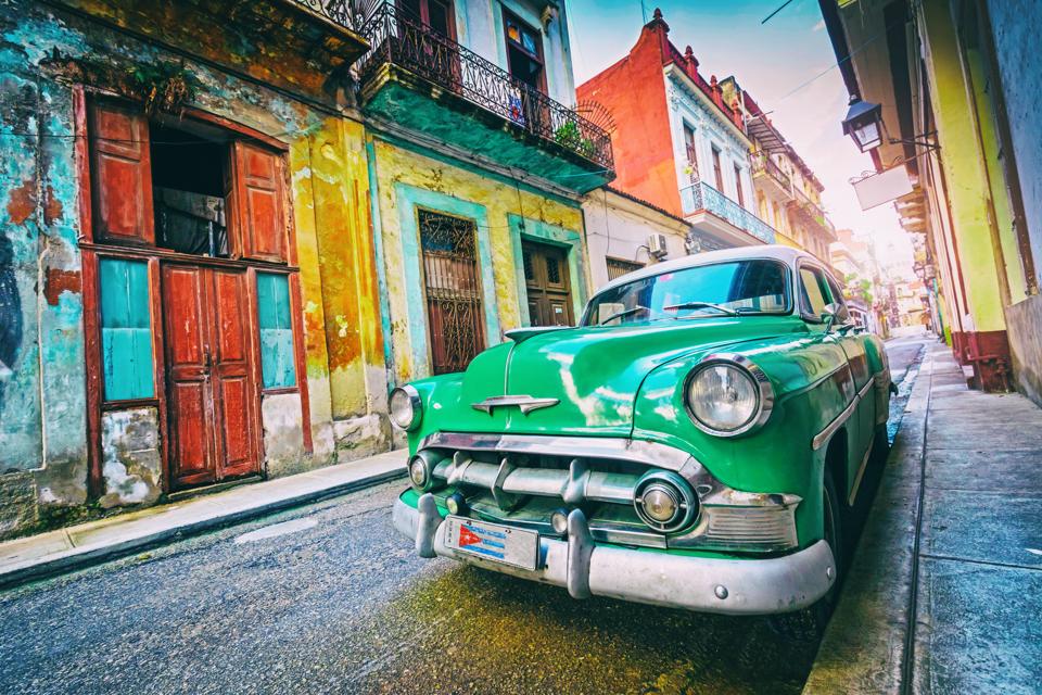Vintage oldtimer car driving through Old Havana Cuba