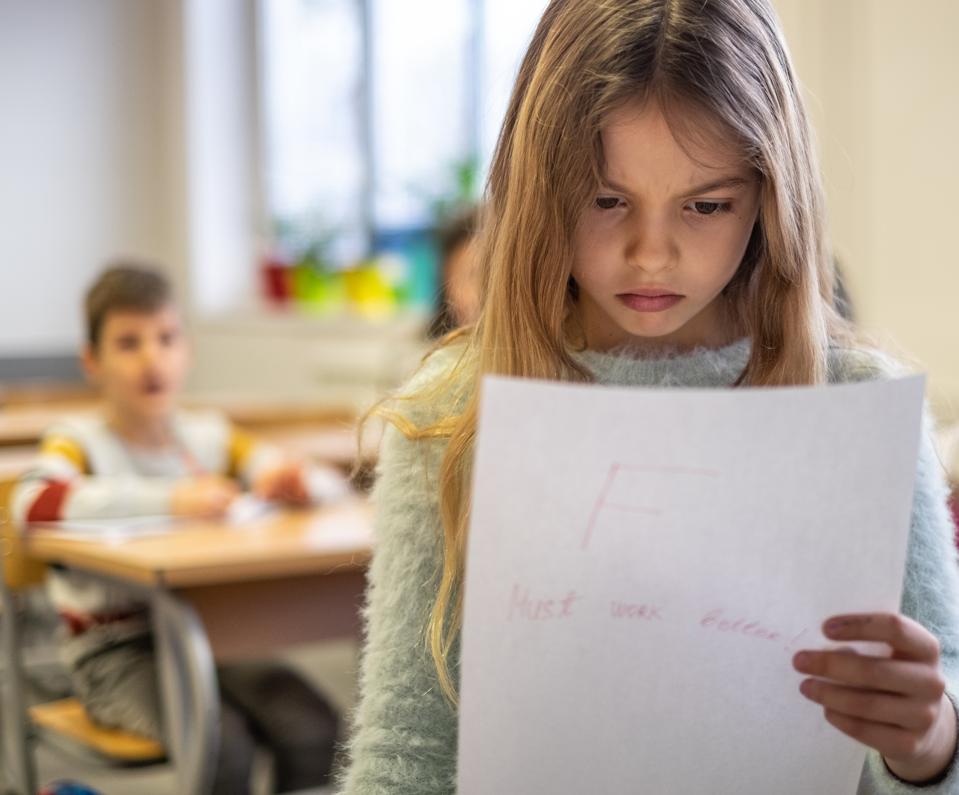Beautiful schoolgirl is sad because bad grade
