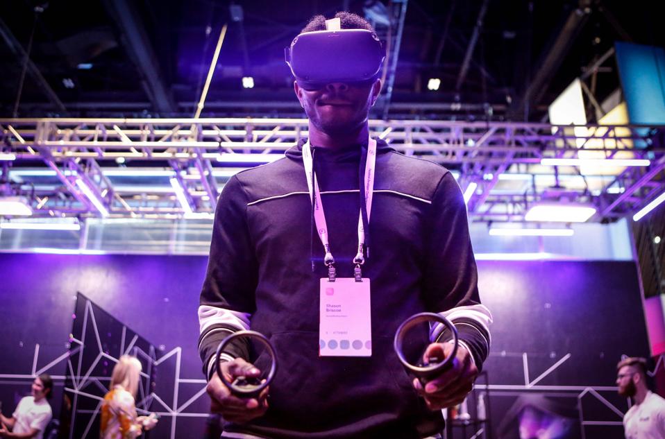 An attendee tries out the new Oculus Quest at the Facebook F8 Conference at McEnery Convention Center in San Jose, California, on April 30, 2019. - Got a crush on another Facebook user? The social network will help you connect, as part of a revamp unveiled Tuesday that aims to foster real-world relationships and make the platform a more intimate place for small groups of friends. (Photo by Amy Osborne / AFP) (Photo credit should read AMY OSBORNE/AFP via Getty Images)