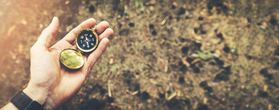 direction search exploration concept - compass in hand