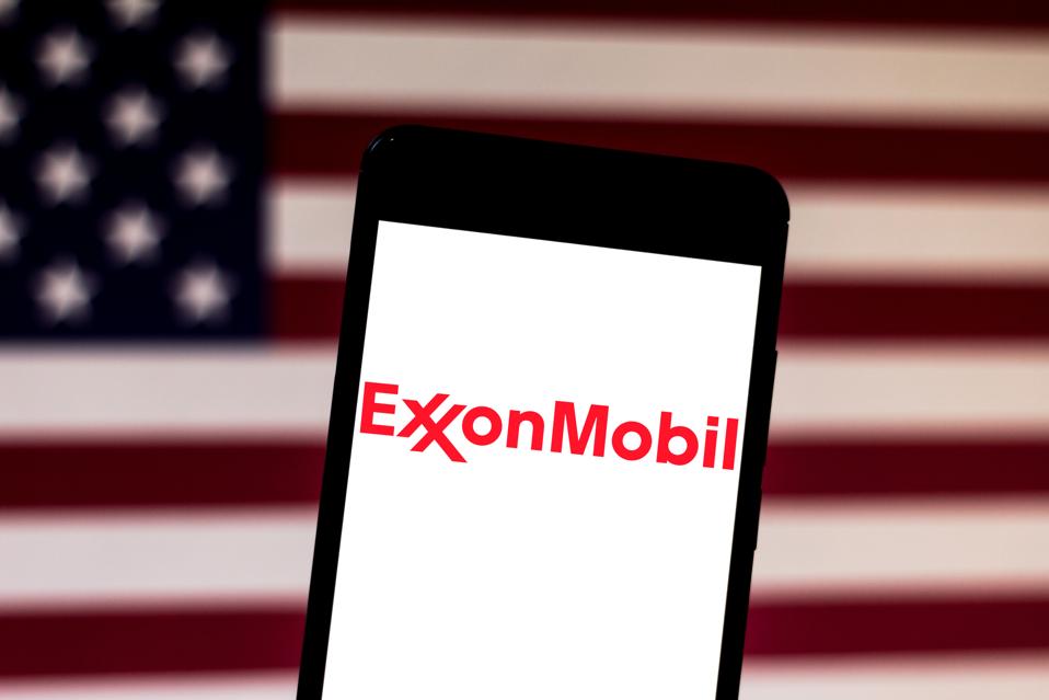 In this photo illustration the Exxon Mobil Corporation logo...