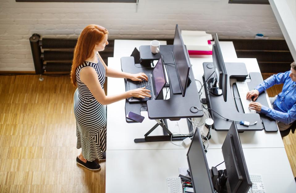 Woman working at ergonomic standing desk