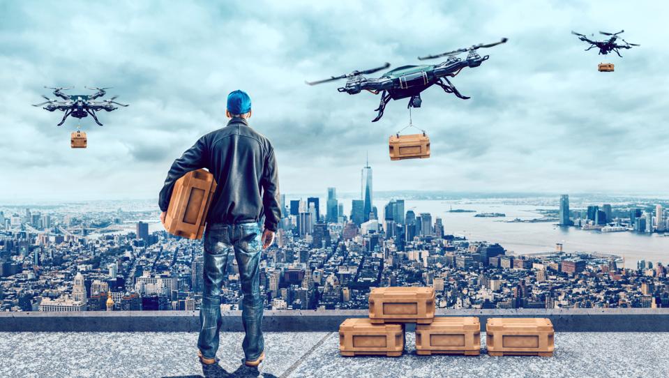 Drone delivers package after being loaded with a box by delivery person