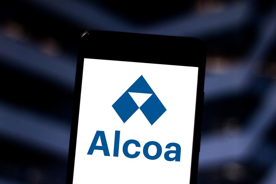 In this photo illustration an Alcoa logo seen displayed on a...