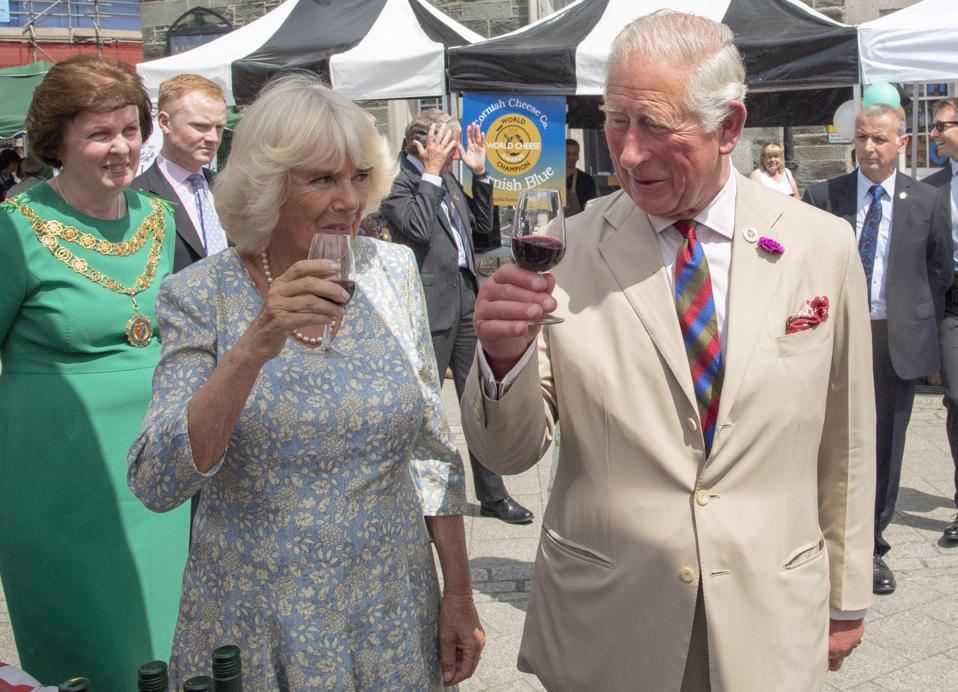 Prince Charles and Camilla, Duchess of Cornwall gesture during their visit to celebrate the recent restoration of historic buildings and to attend the Community Festival of Food and Crafts, in Tavistock, south west England on July 16, 2019. (Photo by Arthur Edwards / various sources / AFP) (Photo credit should read ARTHUR EDWARDS/AFP/Getty Images)