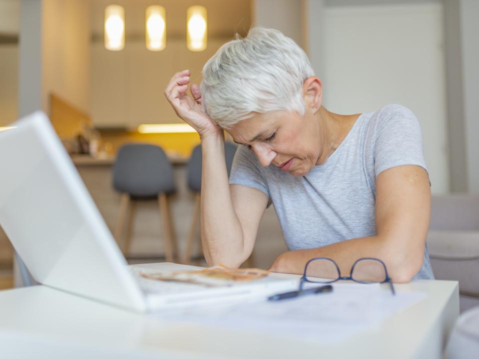 Woman dealing with retirement savings taxes.