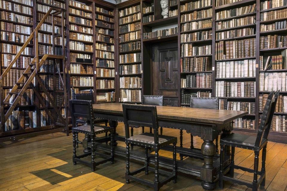 Bookshelves with old books in the Small Library at the Plantin-Moretus Museum.