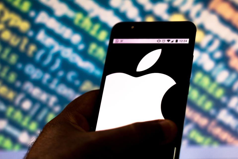 In this photo illustration the Apple logo is seen displayed...