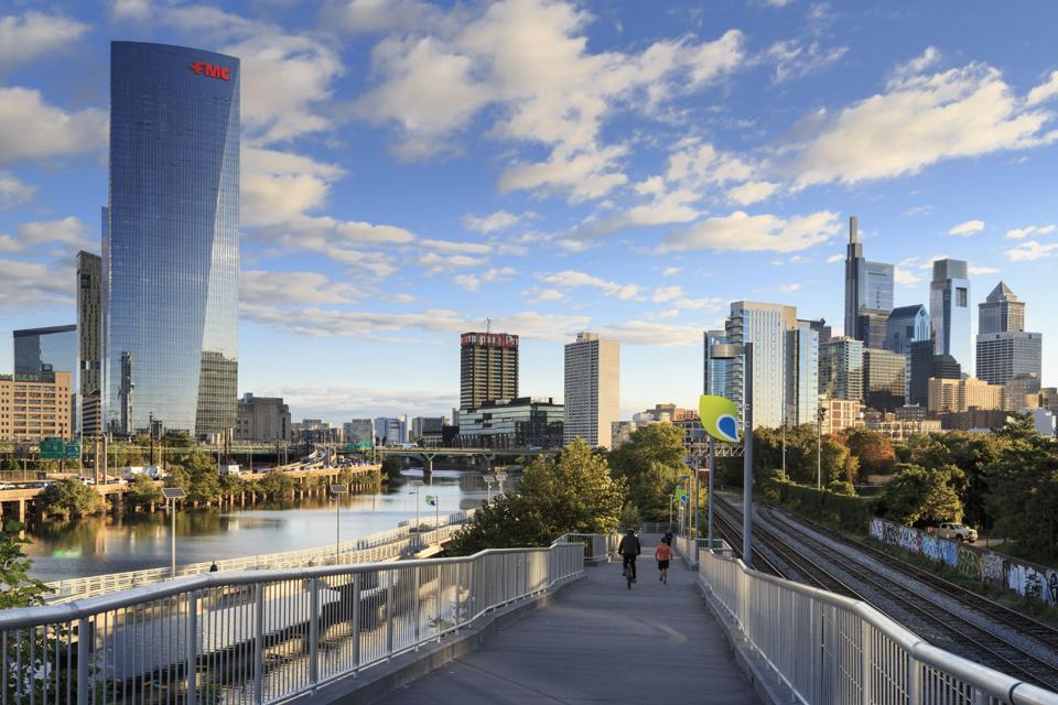 Philadelphia Skyline with Schuylkill River Park Boardwalk in Autumn with Bikers and Joggers, Philadelphia, Pennsylvania, USA