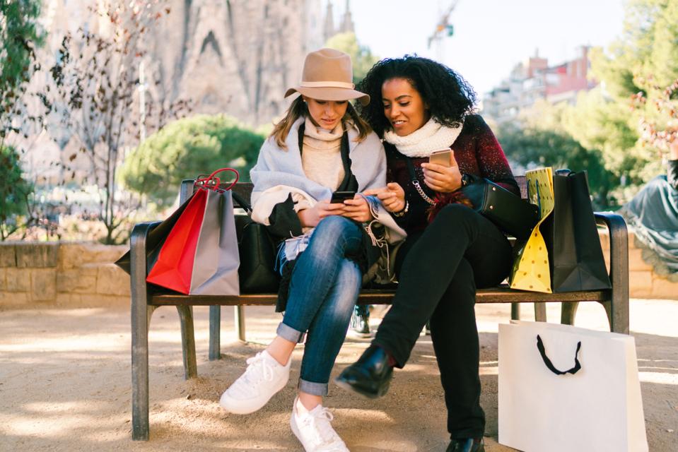 Friends after shopping checking social media