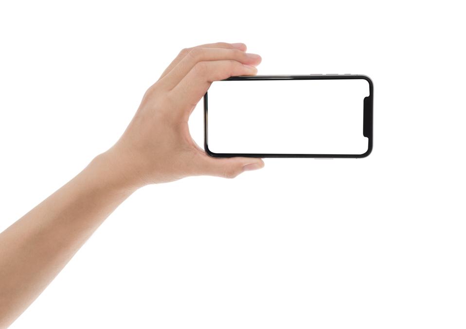 Close up hand holding phone isolated on white, smartphone mockup.