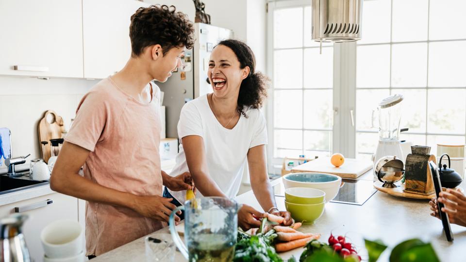 Single Mom Laughing While Preparing Lunch With Son