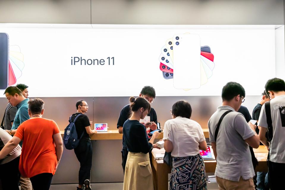 Customers look at the Apple's new iPhone 11 series...