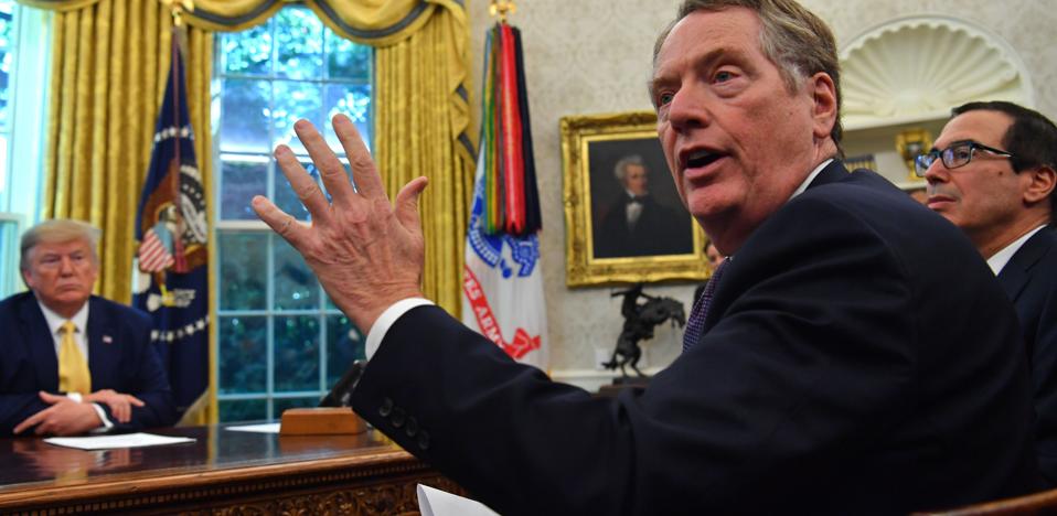 U.S. Trade Representative Robert Lighthizer gestures toward assembled journalists in the Oval Office on Friday in discussing an initial deal with China that put the brakes on the trade war, for the time being. President Trump and Treasury Secretary Steve Mnuchin look on.