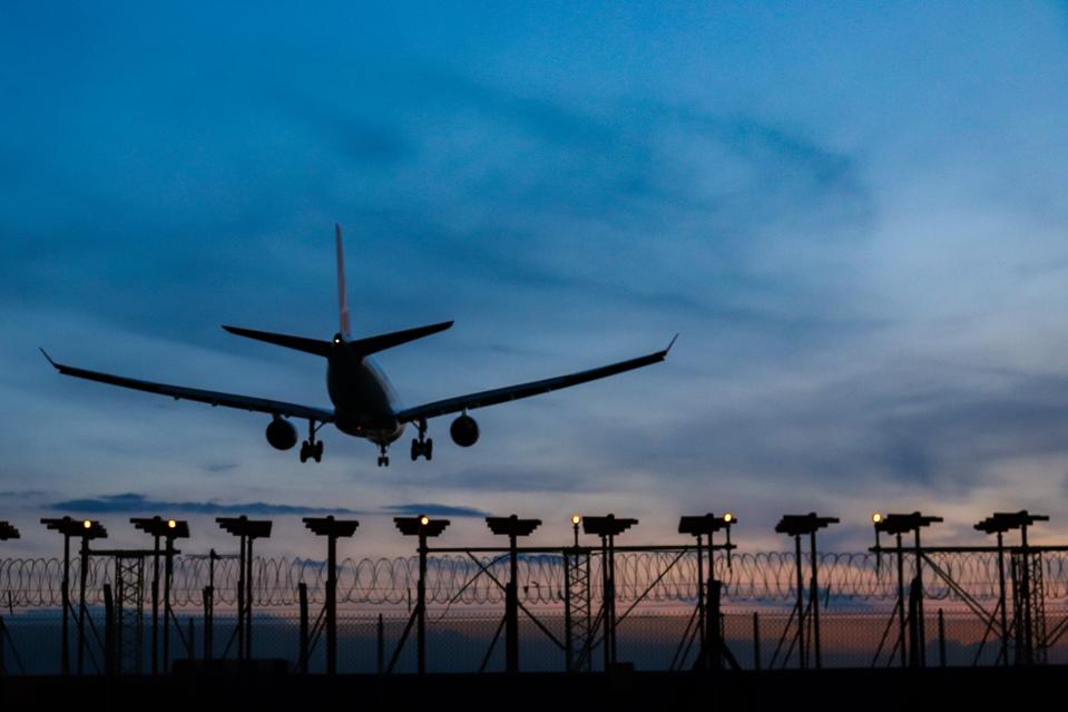 Dusk View Of Airplane At London Heathrow Airport