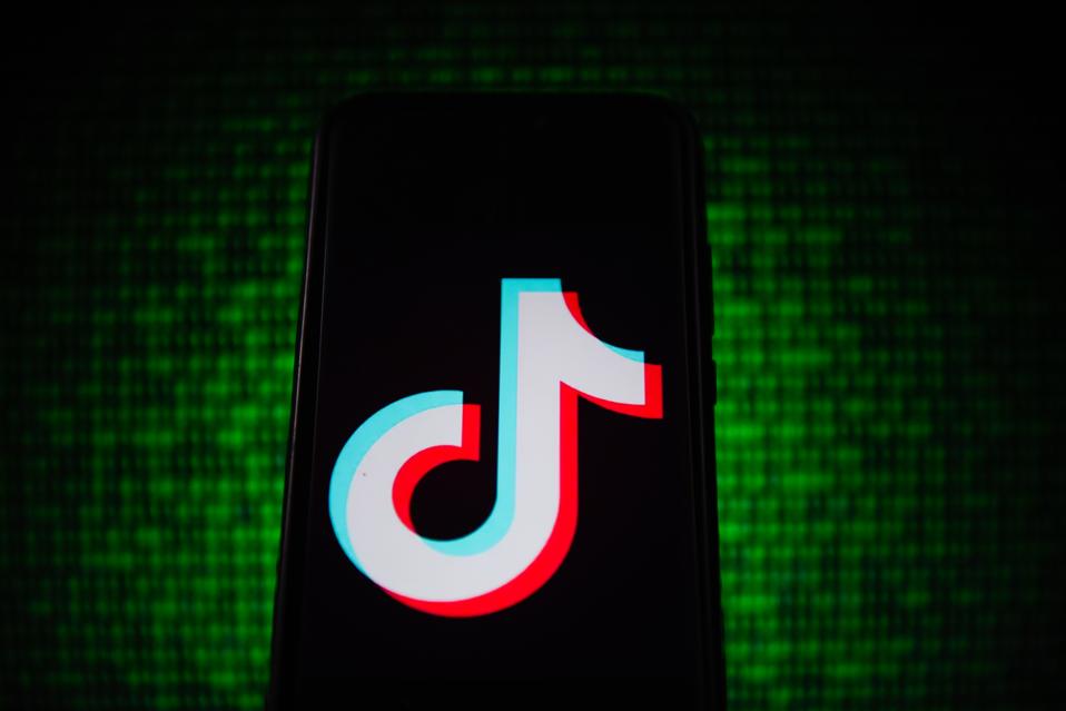 In this photo illustration a TikTok logo seen displayed on a...