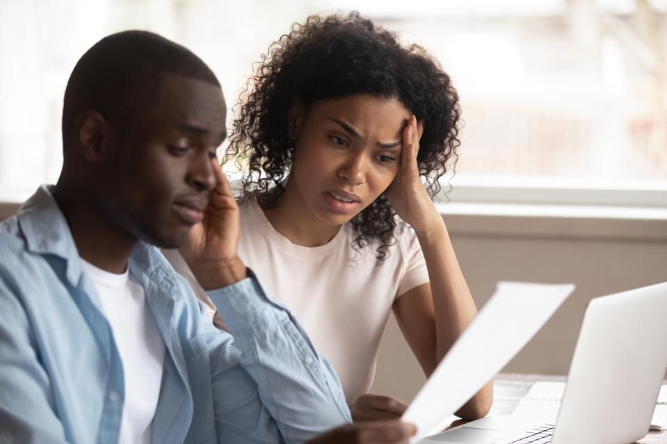 Couple trying to make sense of their investment reports.
