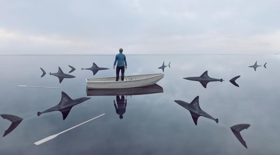 Lost at sea in row boat surrounded by sharks looking for a prey