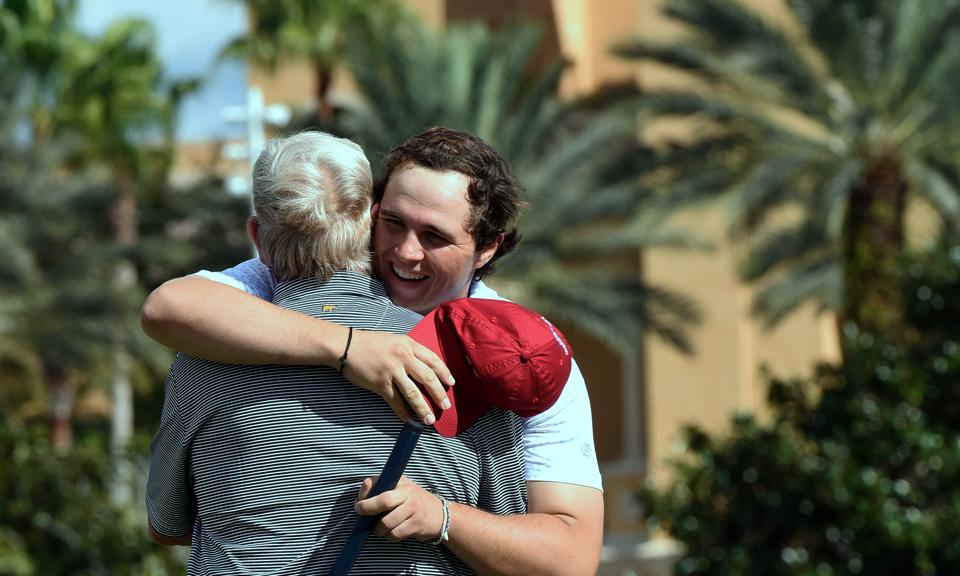 GT Nicklaus hugs his grandfather, Jack Nicklaus, on the 18th...