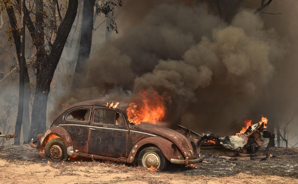 An old car burns in the wake of bushfires in Balmoral, near Sydney on December 19.