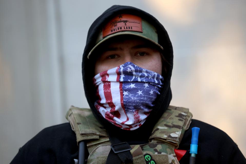 A man with his face covered joins thousands of gun rights advocates attending the rally.