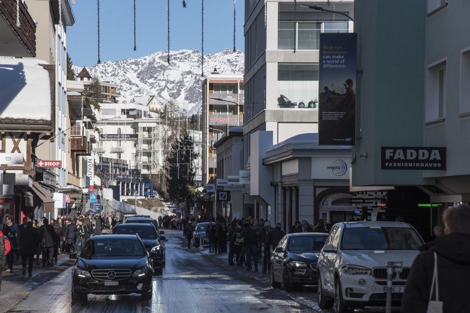 Limousines and cars are queuing up in a main Davos street...