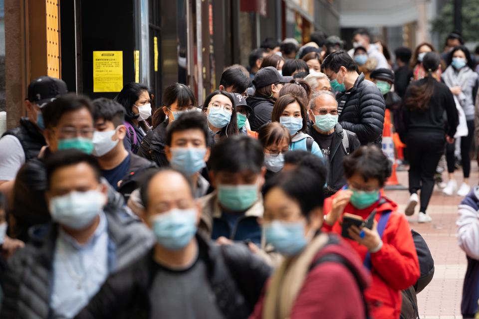 People seen lining up outside a pharmacy store in order to...