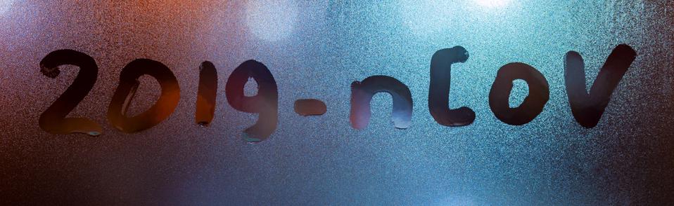 the word 2019-nCoV handwritten on sweat window glass surface at night