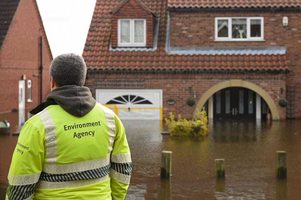Environment Agency staff observe rising floodwater in East Cowick, northern England.