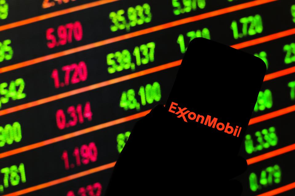 In this photo illustration an Exxon Mobil logo seen...
