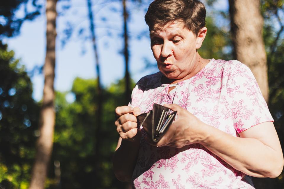 Old woman checking wallet