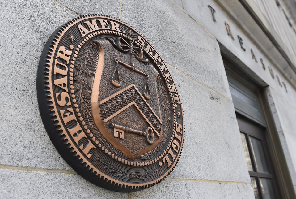 External view of seal on Treasury Department building.