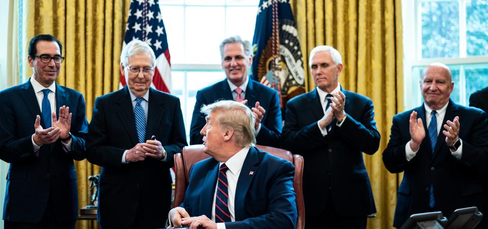 President Trump Signs Coronavirus Stimulus Bill In The Oval Office