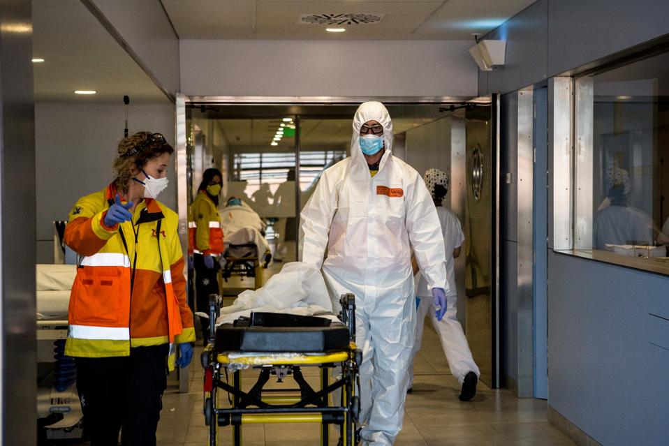 Emergency health workers in protective gear as a preventive...