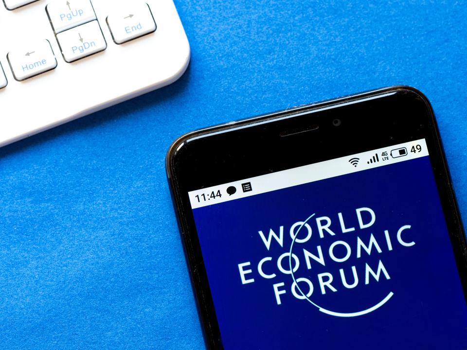 In this photo illustration a World Economic Forum logo seen...