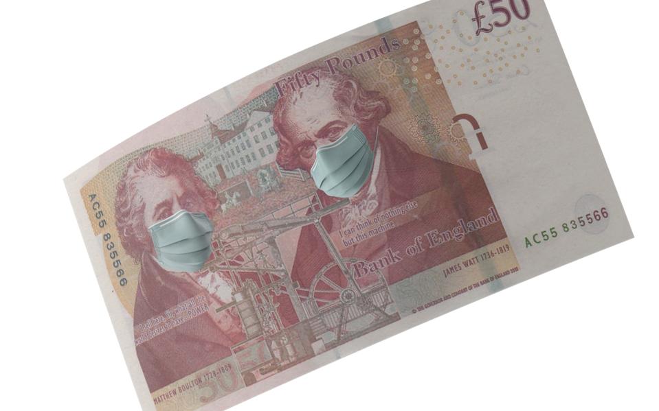 British Fifty Pound Note with Mask Protection For Coronavirus on Economy Against White Background