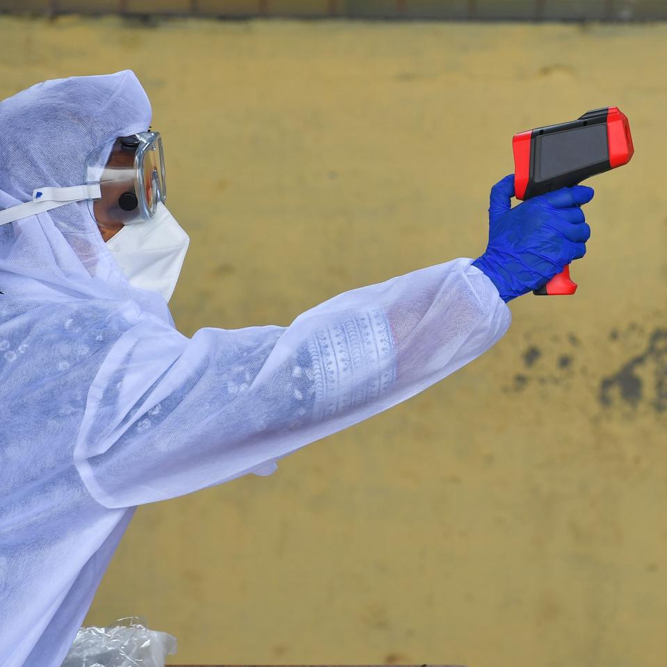 Image: https://specials-images.forbesimg.com/imageserve/1213413687/A-doctor-in-multiple-pieces-of-PPE-performs-a-body-temperature-test/960x0.jpg?cropX1=0&cropX2=2672&cropY1=0&cropY2=2673 A doctor in multiple pieces of PPE performs a body temperature test