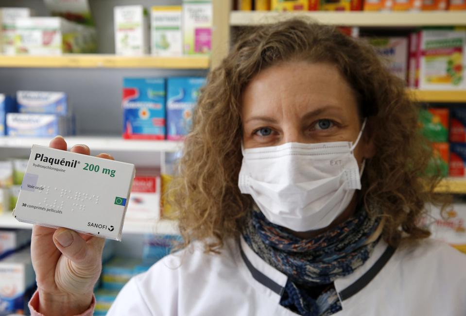 A pharmacy employee with a box of Plaquenil (Hydroxychloroquine) on March 27, 2020 in Paris, France.