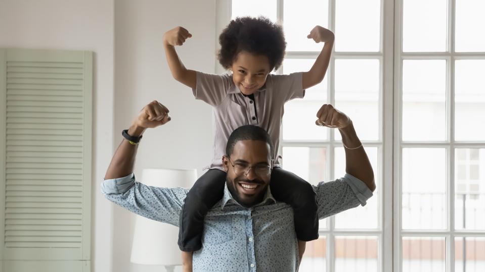 son sitting on father's shoulders