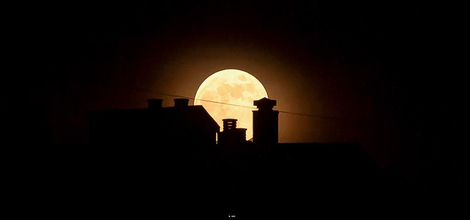 The strawberry full moon, as part of a penumbral lunar...